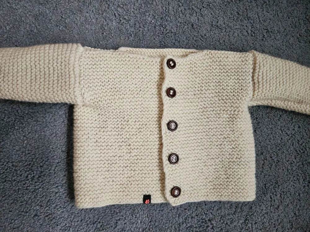 nullStrickjacke Baby Wollweiß Größe 68/74 6-9 monthStrickjacke Baby Wollweiß in Größe 68/74. Unsere handgestrickte Baby Strickjacke aus weicher Wolle in Wollweiß ist perfekt für die kalten Tage geeignet. Die Jacke is